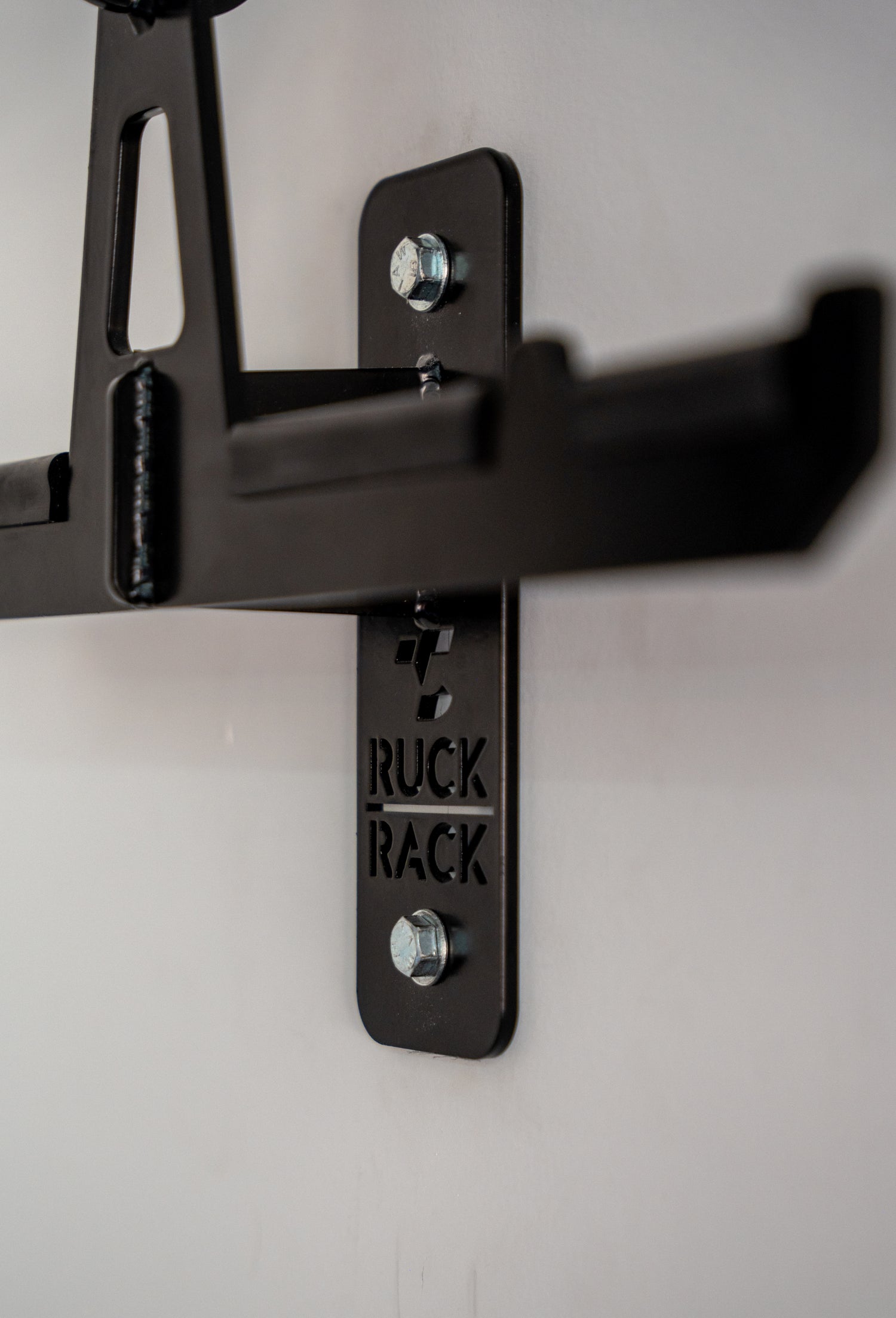 Close up photo of the Ruck Rack Alpha | Plate Carrier Hanger with Combat Helmet and Duty Belt positions